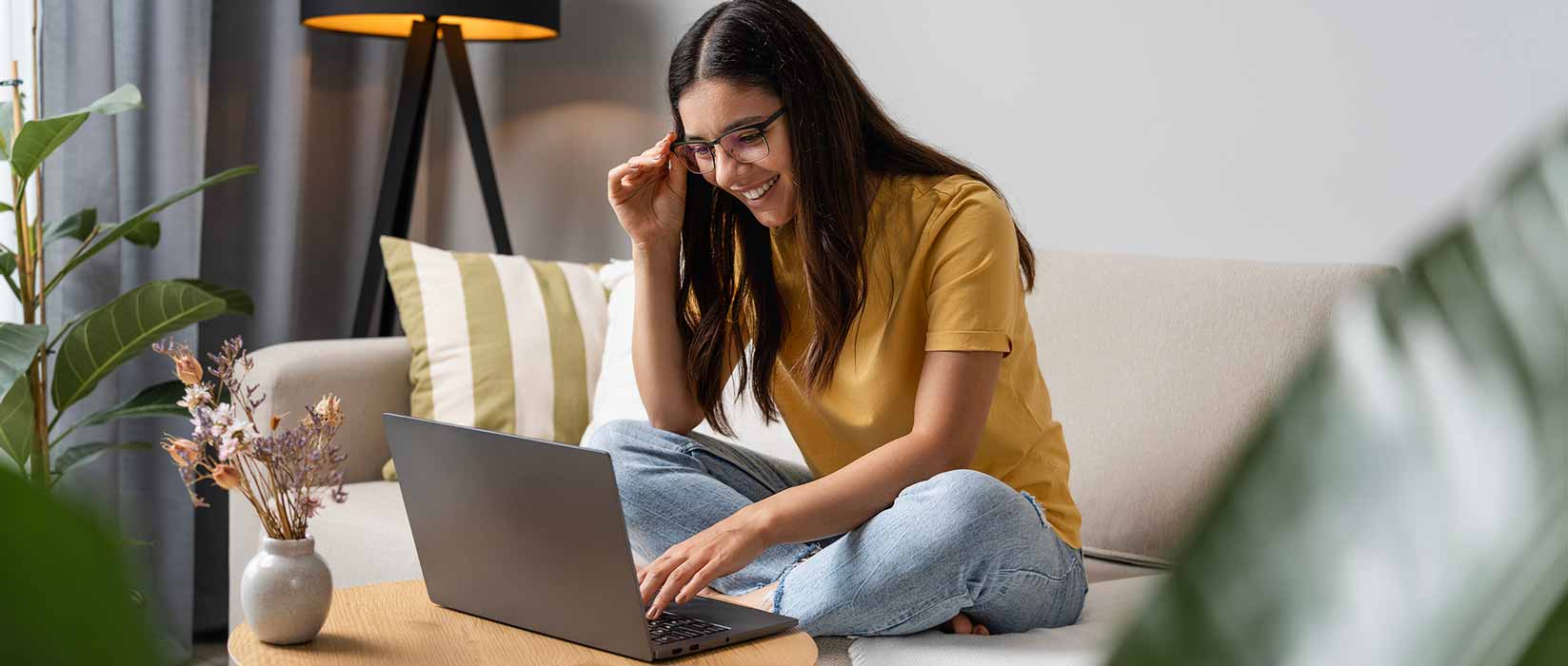 Teenager using laptop and smiling