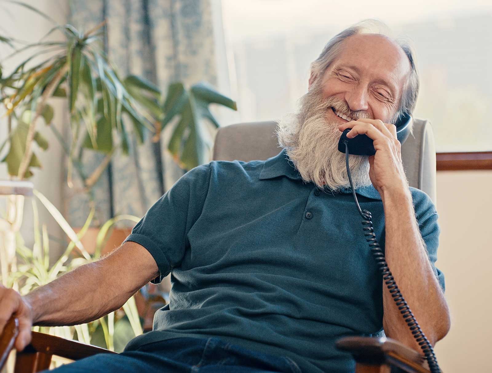 Elderly man taking on home phone